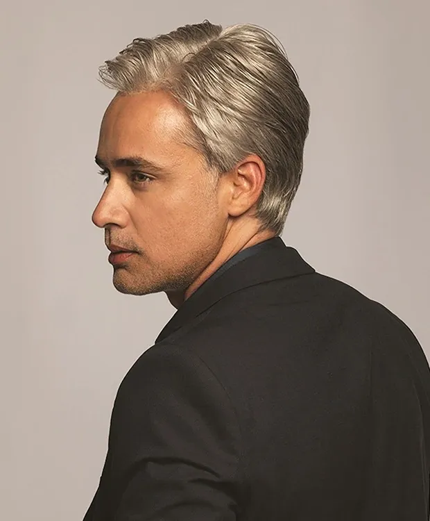 A man in a suit with gray hair.