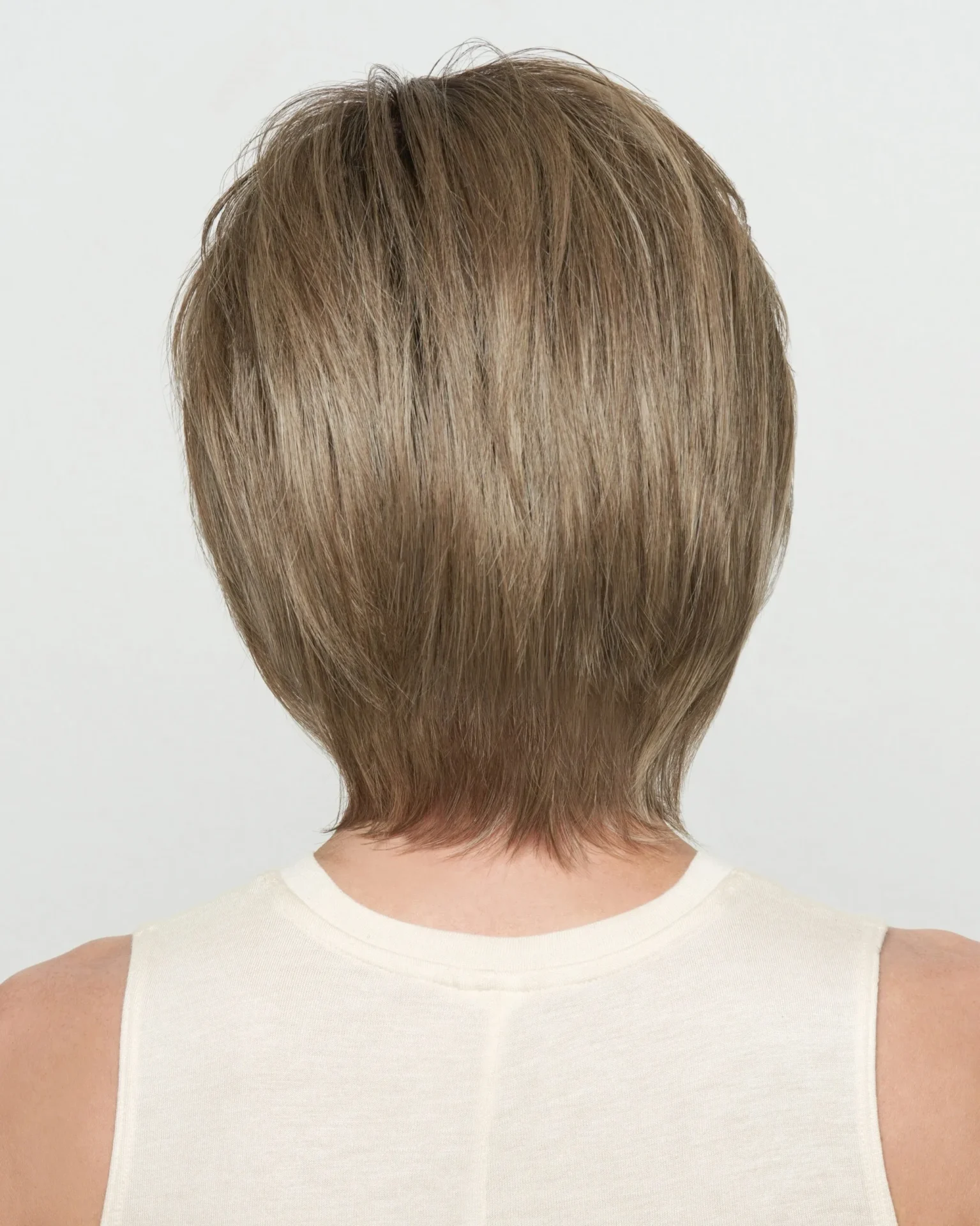 The back view of a woman with a short blonde wig.